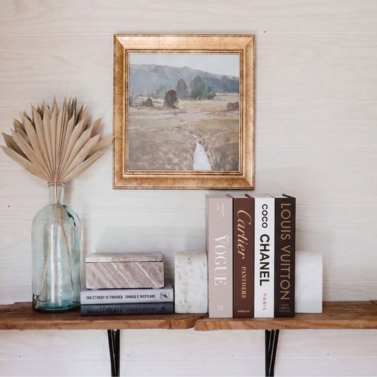 Faux Decorative Books vs Real Books: Why Every Stylist Is Making the Switch — Decorative books styled with a gold frame and vase
