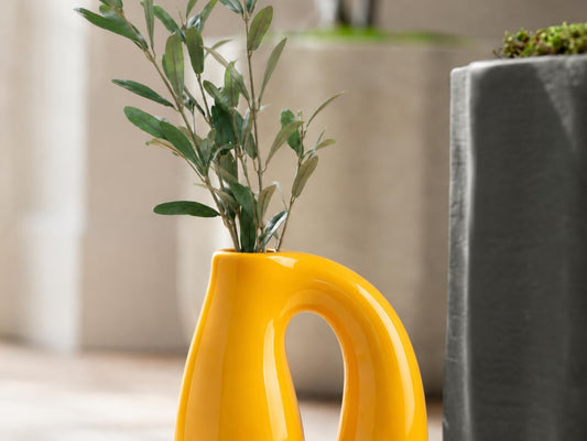 Yellow vase styled with tulips
