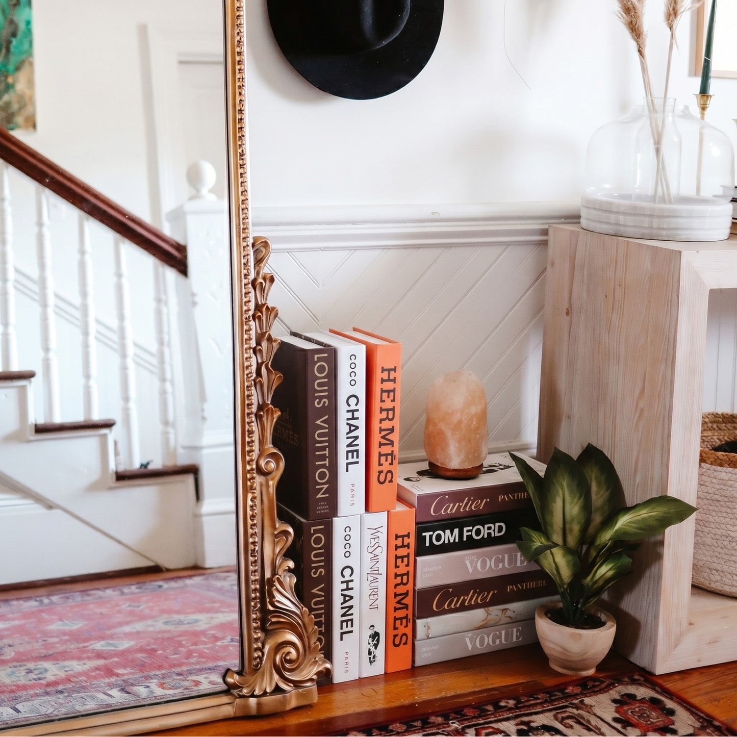 Mocha books styled on a stairway shelf
