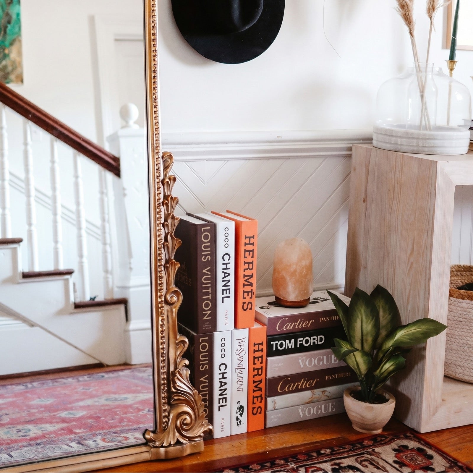 Mocha books styled on a stairway shelf